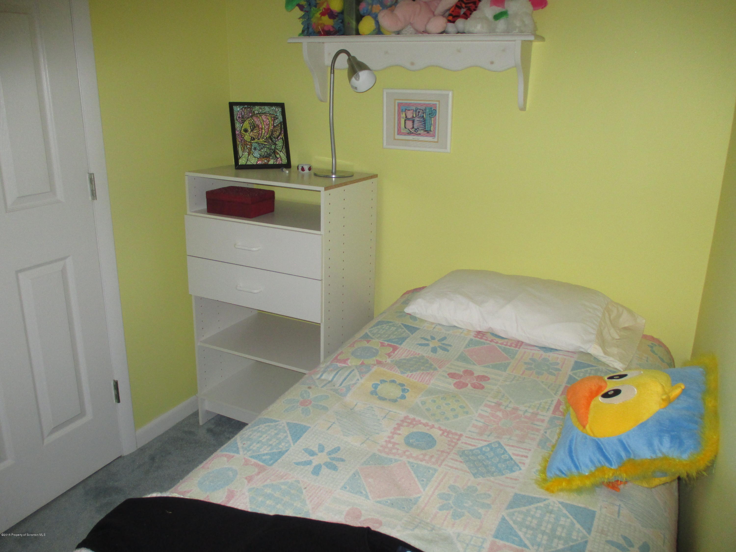 394 Point Road Lake Winola, PA 18419 - Photo 21 of 28 a bedroom with a bed and ceiling fan