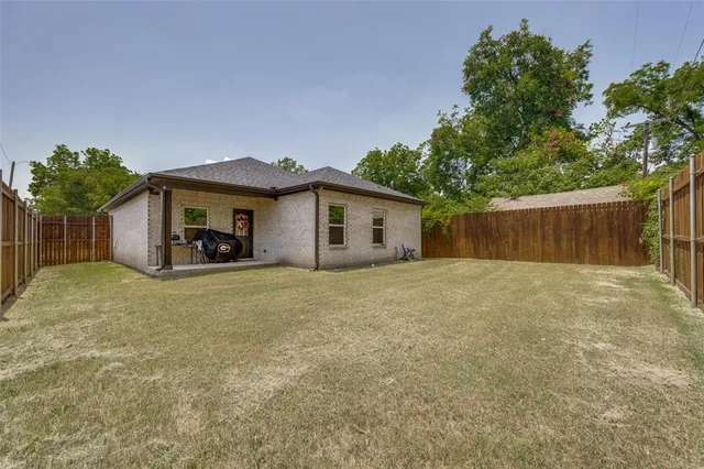 a view of a house with a yard and a garage