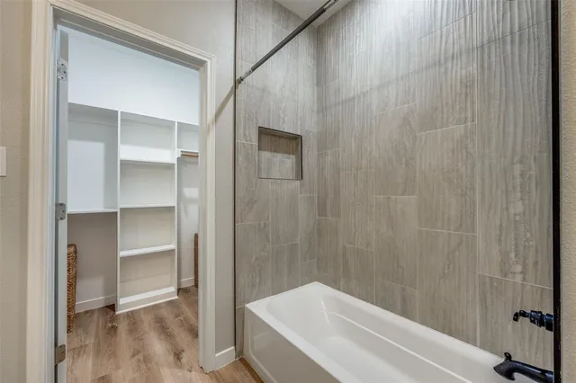a bathroom with a bathtub and a shower