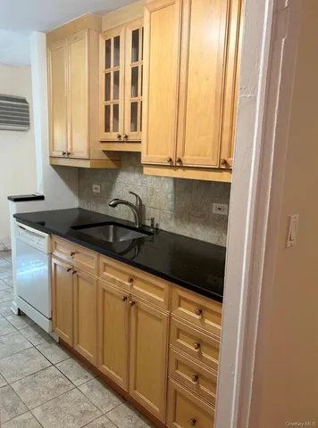 a kitchen with granite countertop white cabinets and sink