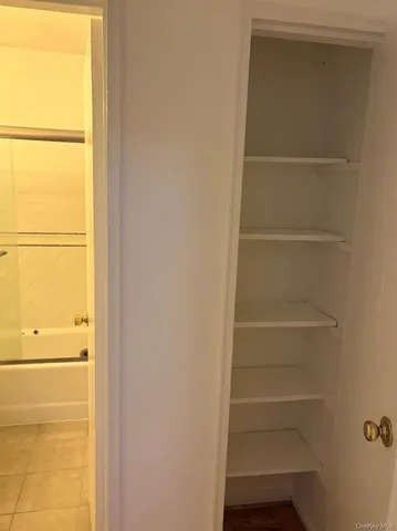 a view of walk in closet with empty racks