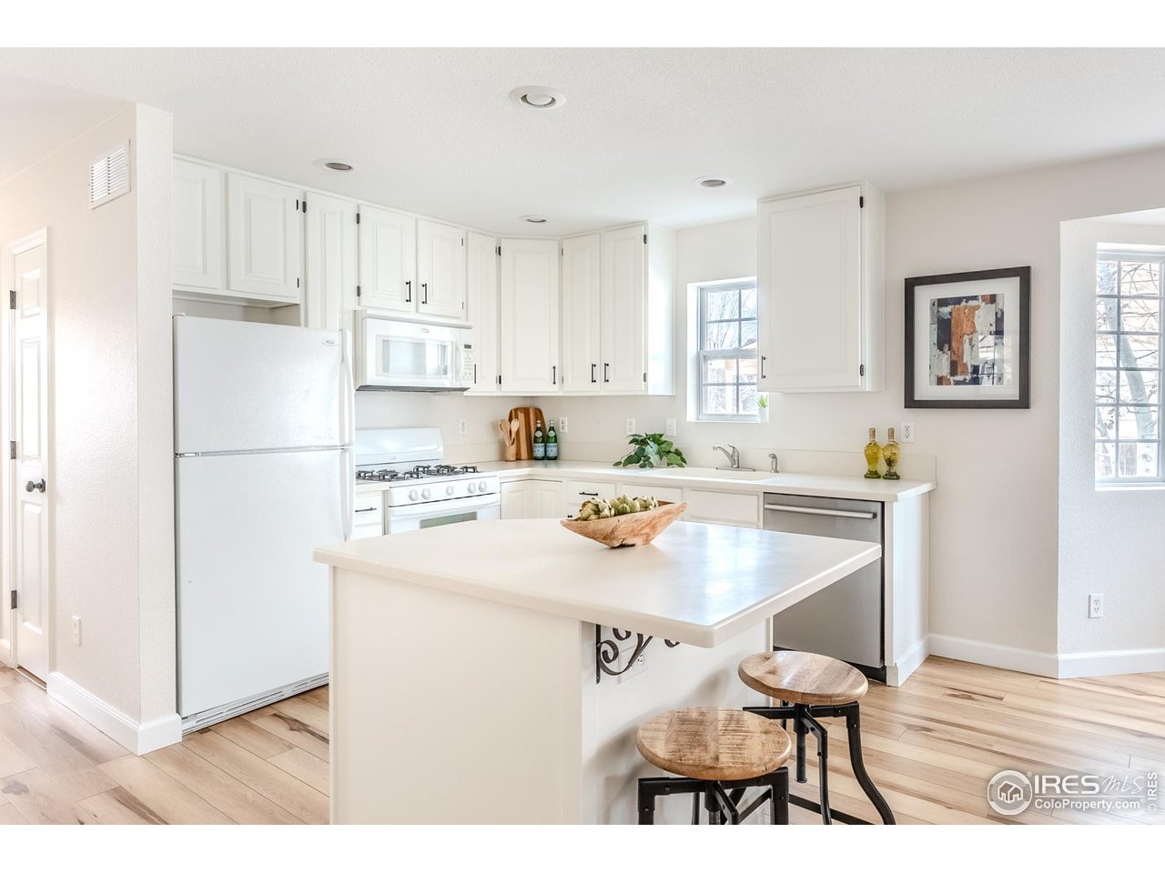 502 Ridge Avenue Longmont, CO 80501 - Photo 11 of 36 a kitchen with a table chairs and a refrigerator