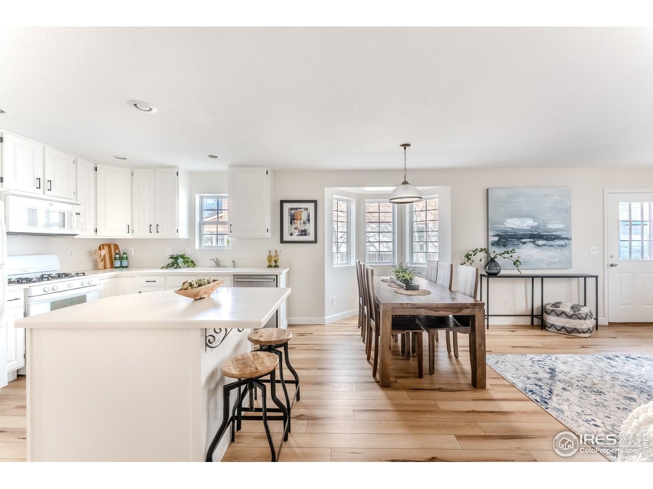 502 Ridge Avenue Longmont, CO 80501 - Photo 12 of 36 a view of a dining room with furniture window and wooden floor