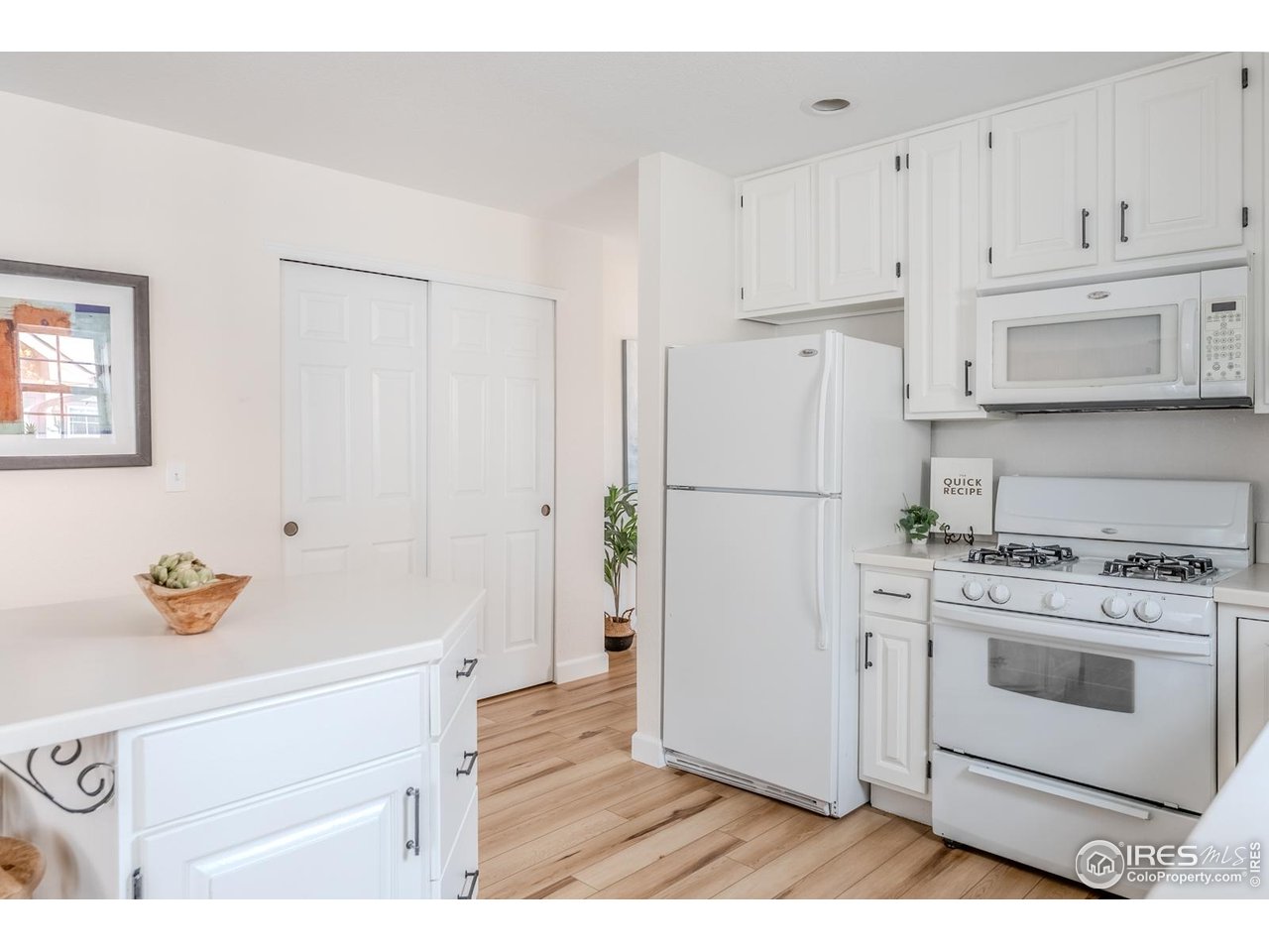 502 Ridge Avenue Longmont, CO 80501 - Photo 16 of 36 a kitchen with stainless steel appliances white cabinets and a refrigerator