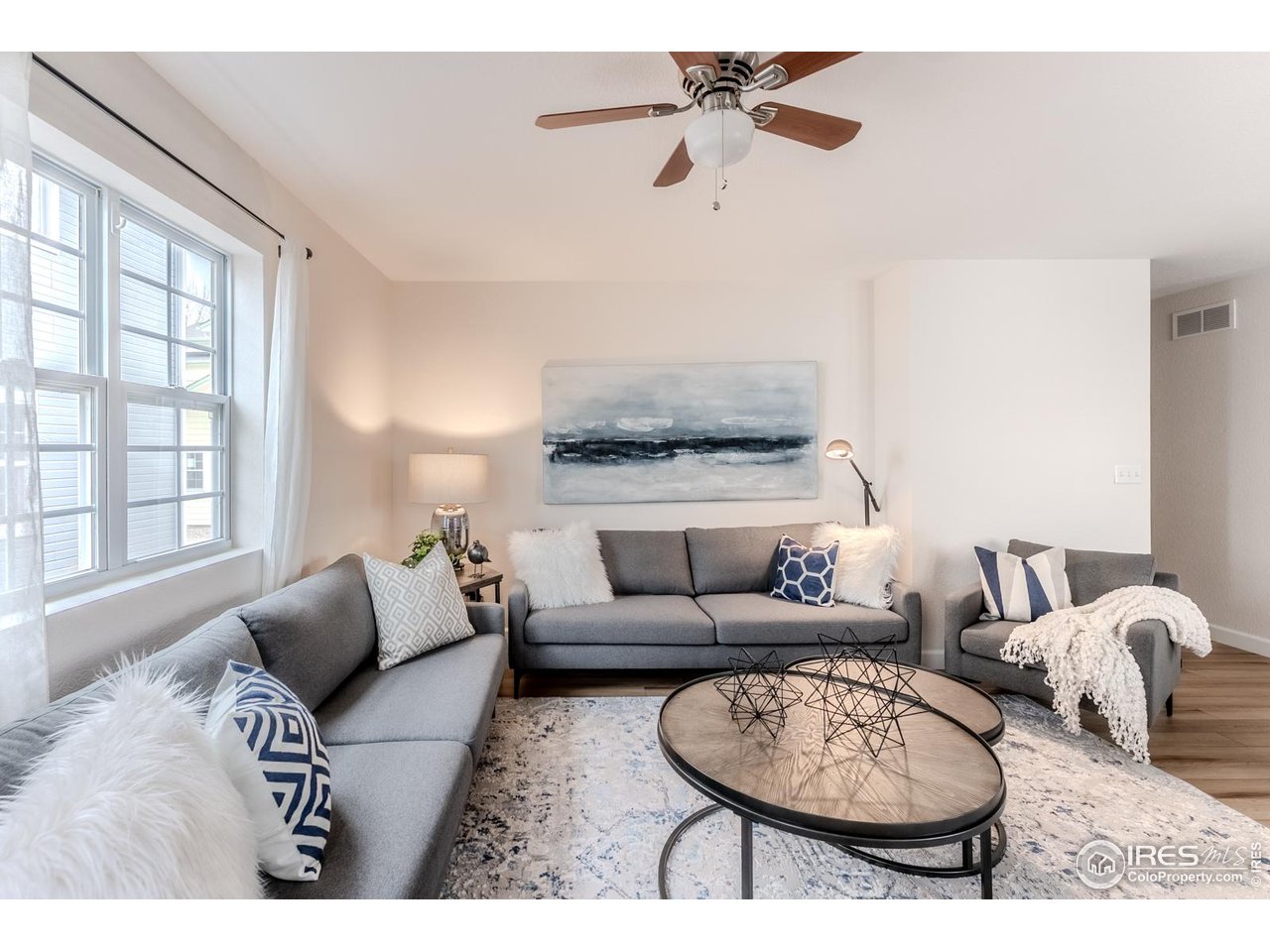 502 Ridge Avenue Longmont, CO 80501 - Photo 17 of 36 a living room with furniture a rug potted plant and a window