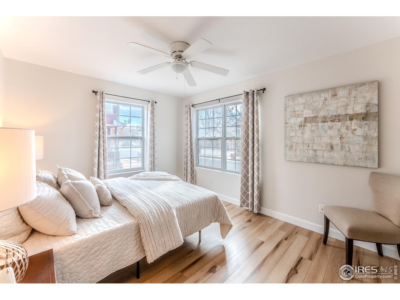 502 Ridge Avenue Longmont, CO 80501 - Photo 20 of 36 a bedroom with a bed and wooden floor
