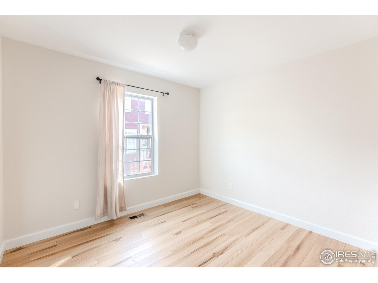 502 Ridge Avenue Longmont, CO 80501 - Photo 26 of 36 a view of an empty room with wooden floor and a window