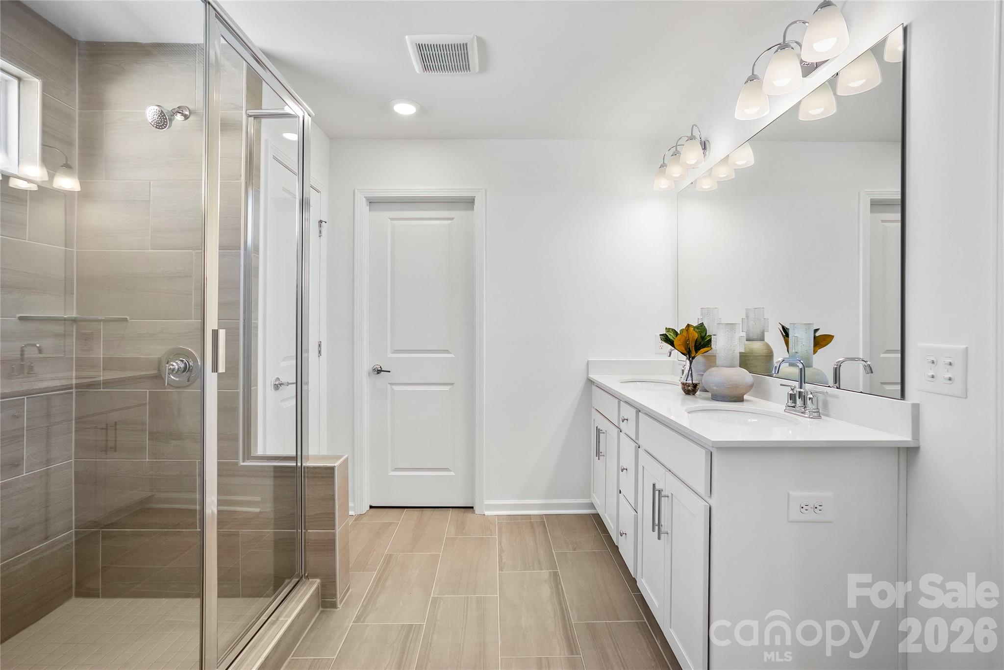 2168 Rone Branch Trail Monroe, NC 28110 - Photo 19 of 22 a bathroom with a sink a mirror and shower