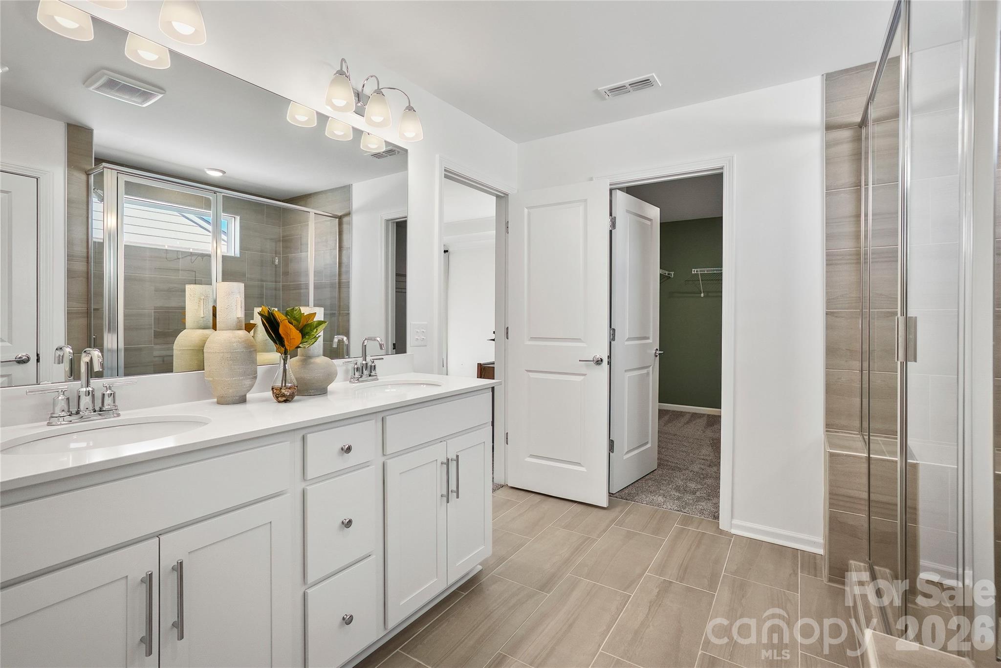 2168 Rone Branch Trail Monroe, NC 28110 - Photo 20 of 22 a spacious bathroom with a double vanity sink a mirror and shower