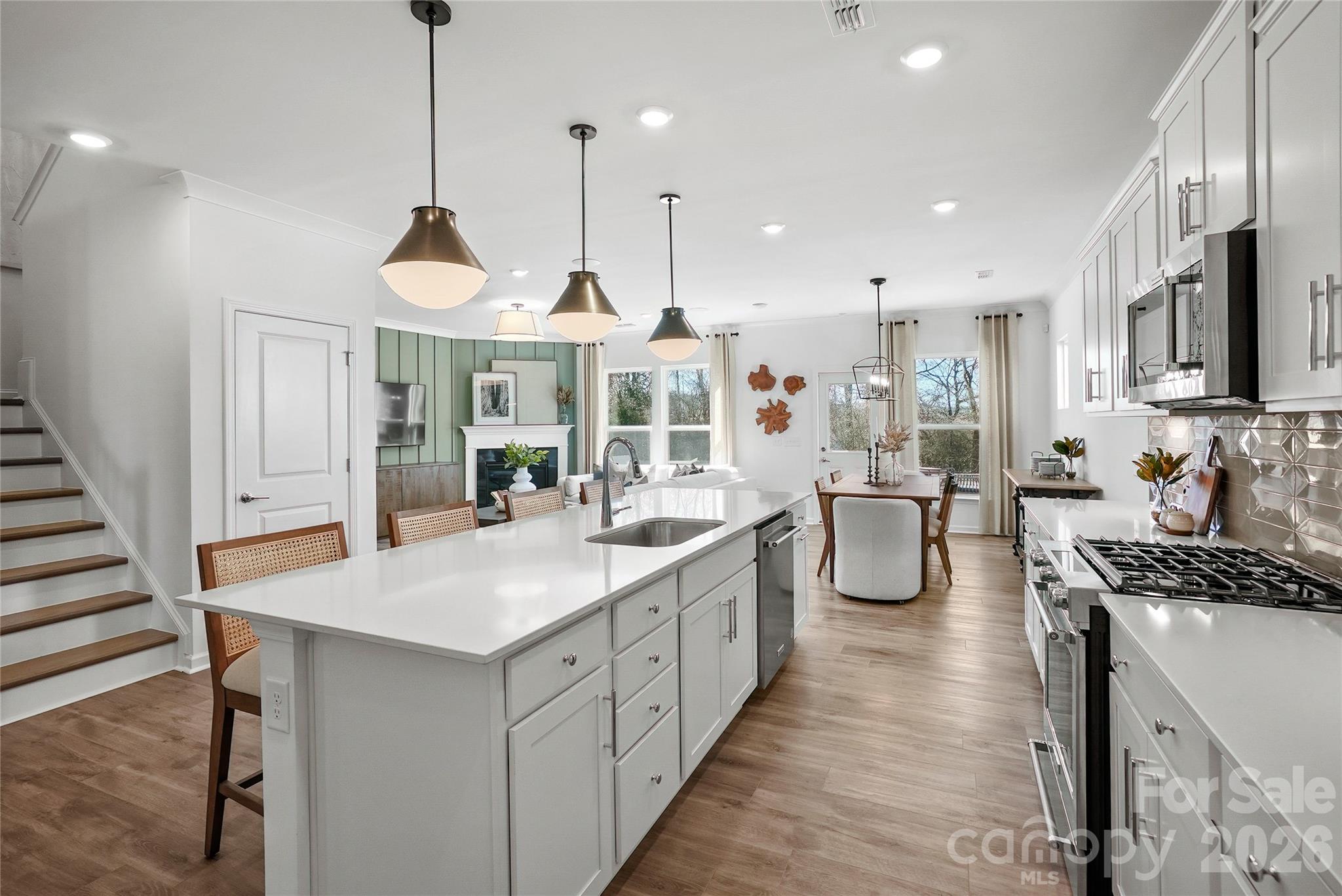 2168 Rone Branch Trail Monroe, NC 28110 - Photo 7 of 22 a open kitchen with stainless steel appliances granite countertop a stove and kitchen island