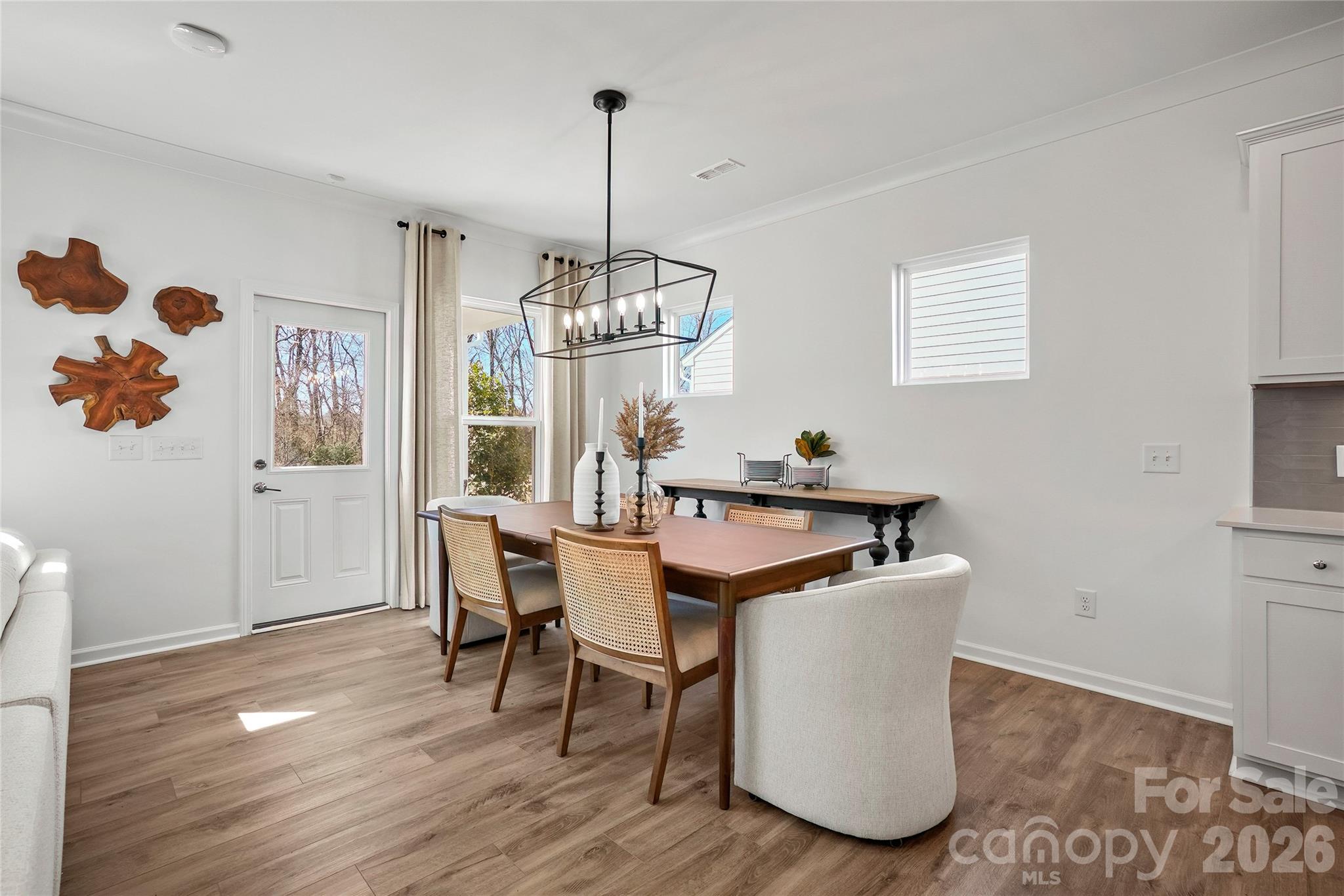 2168 Rone Branch Trail Monroe, NC 28110 - Photo 8 of 22 a view of a dining room with furniture a chandelier and wooden floor