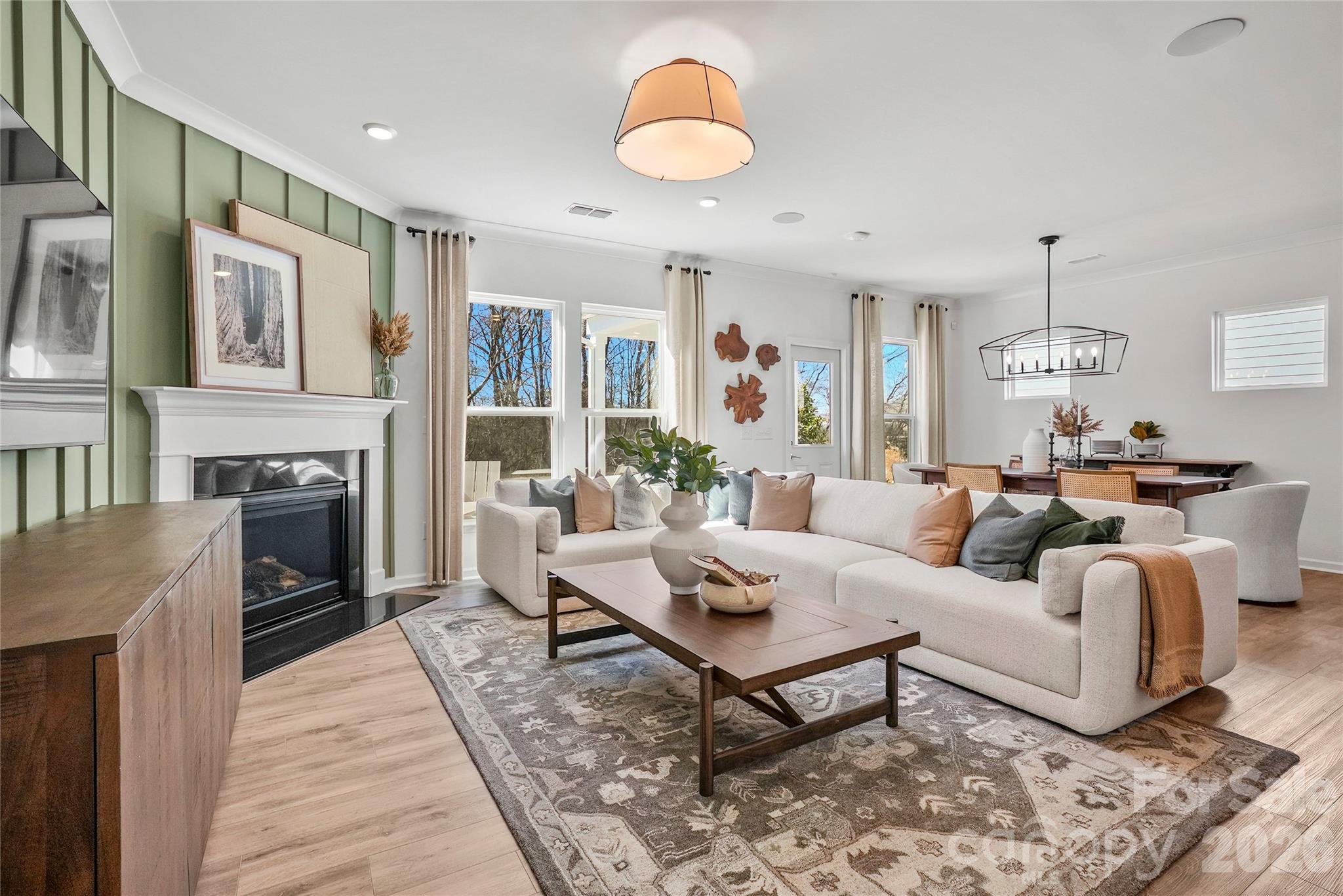 2168 Rone Branch Trail Monroe, NC 28110 - Photo 10 of 22 a living room with furniture a fireplace and a chandelier