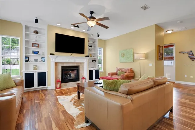 a living room with fireplace furniture and a flat screen tv