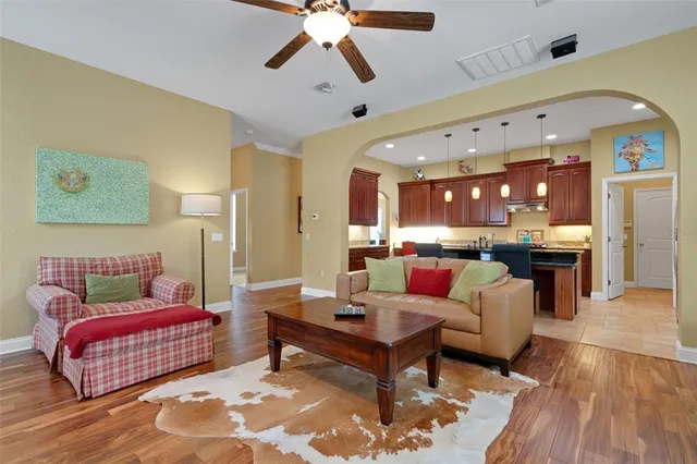 a living room with furniture and a view of kitchen