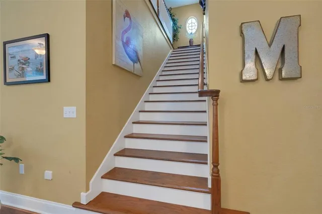 a view of staircase with wooden floor