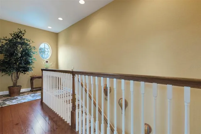 a view of staircase with wooden floor and a potted plant