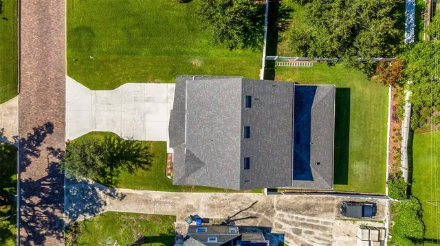 aerial view of a house with a yard