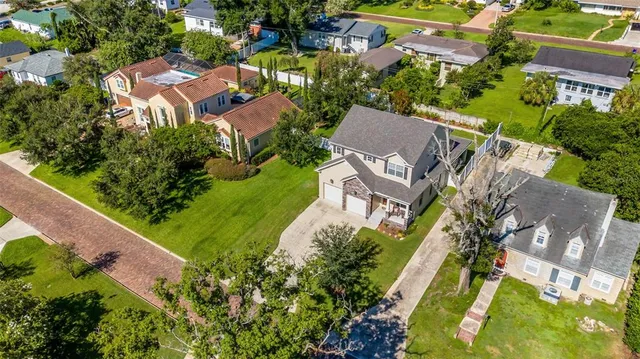 an aerial view of multiple houses with yard