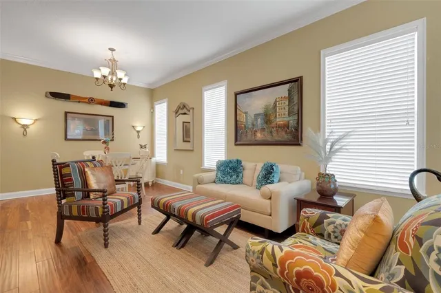 a living room with furniture and a chandelier