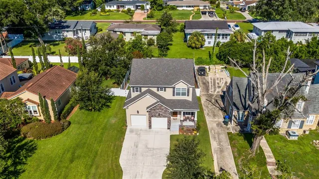 an aerial view of multiple houses with yard