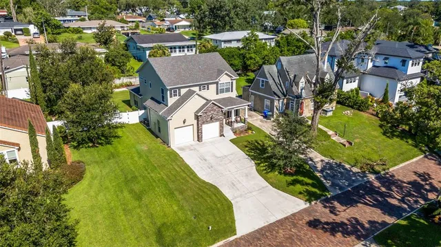 an aerial view of a house with a garden and swimming pool