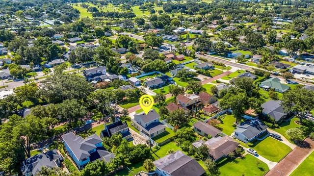 an aerial view of a house with a garden and swimming pool