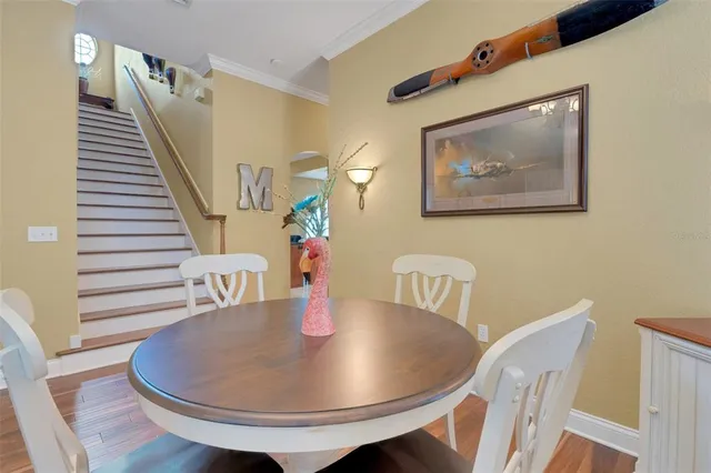 a view of a dining room with furniture and wooden floor