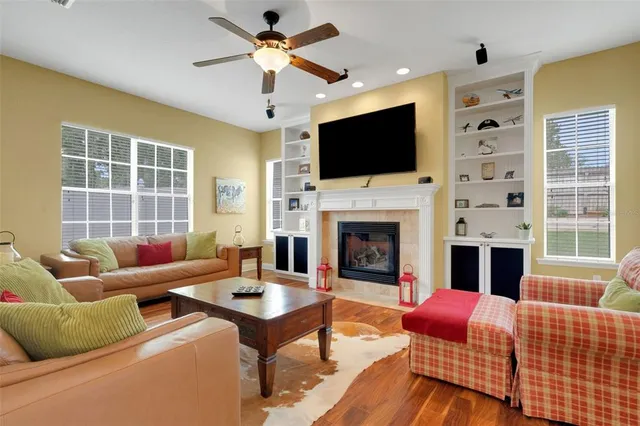a living room with furniture a fireplace and a flat screen tv