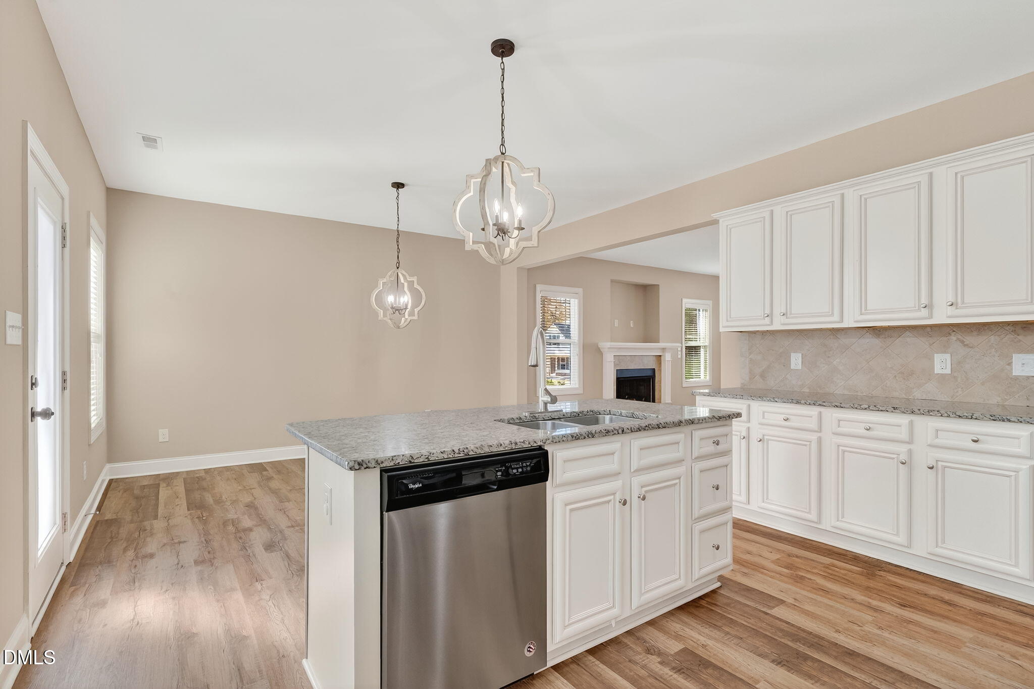 118 Landlocked Circle Angier, NC 27501 - Photo 11 of 27 a kitchen with a sink dishwasher and white cabinets with wooden floor