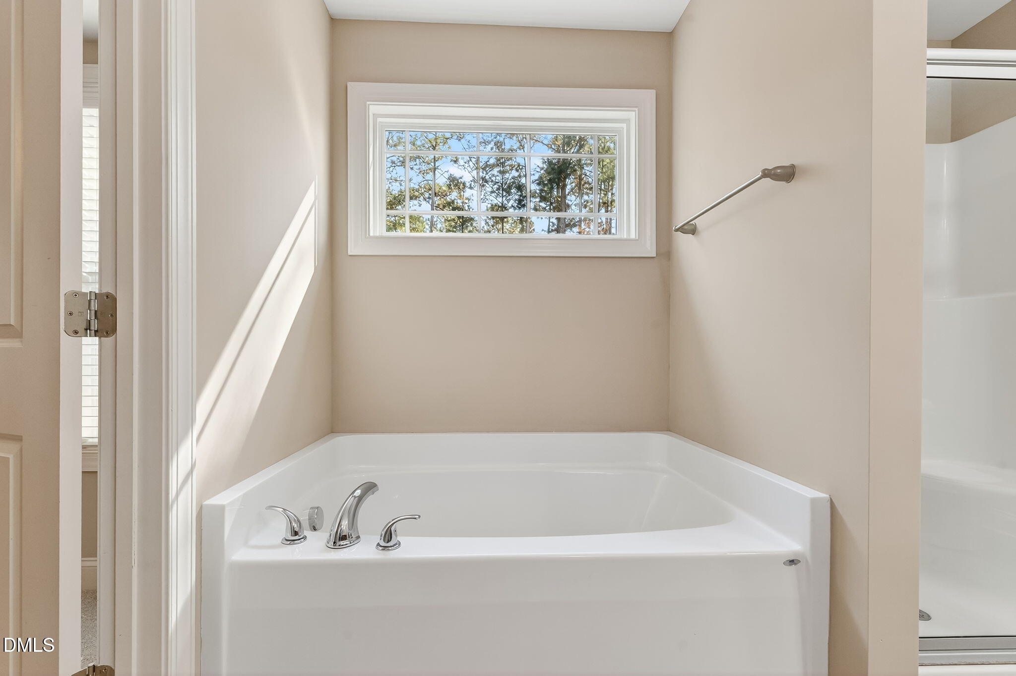 118 Landlocked Circle Angier, NC 27501 - Photo 15 of 27 a bathroom with bathtub and window