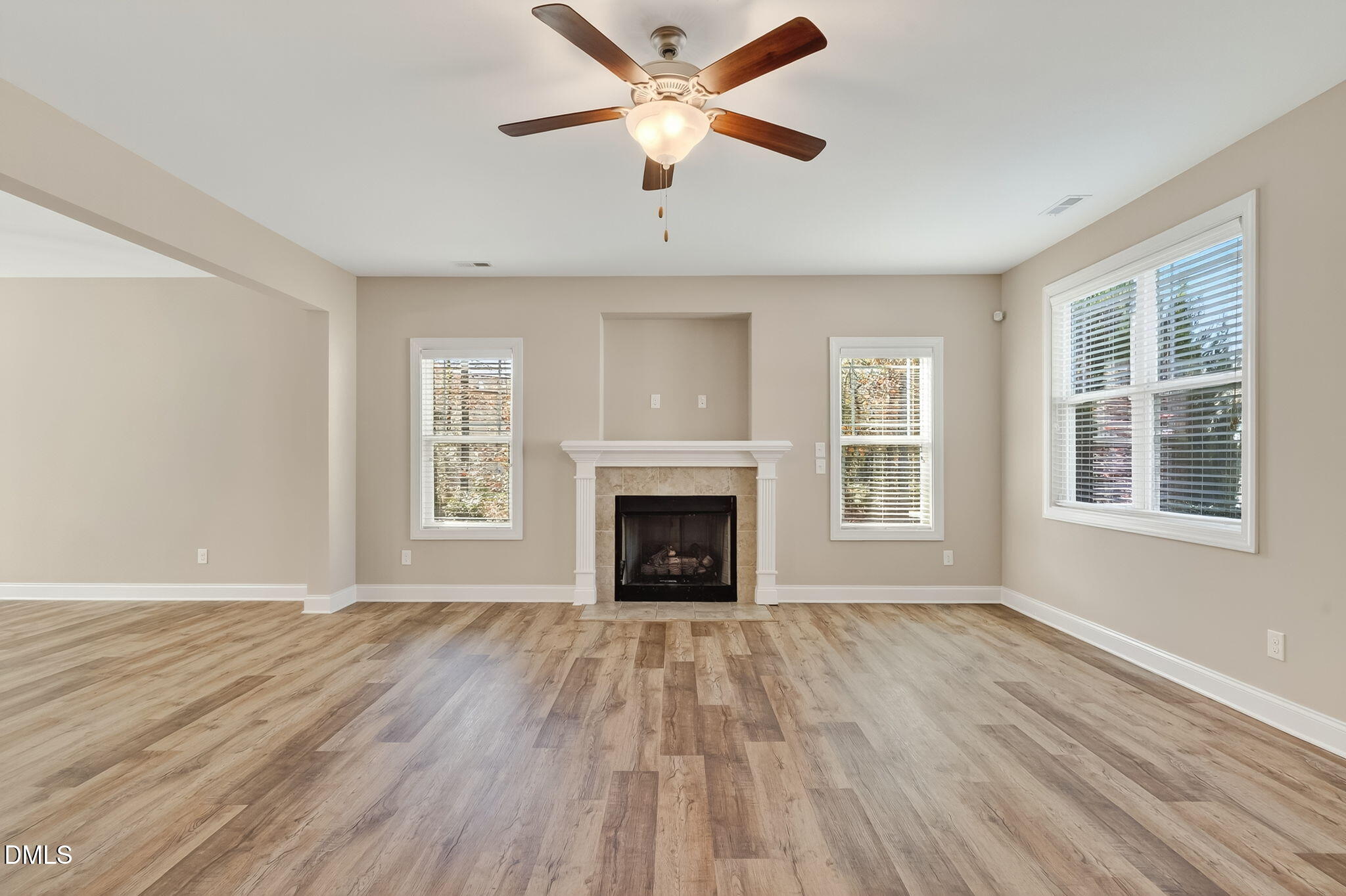 118 Landlocked Circle Angier, NC 27501 - Photo 6 of 27 a view of an empty room with wooden floor fireplace and a window