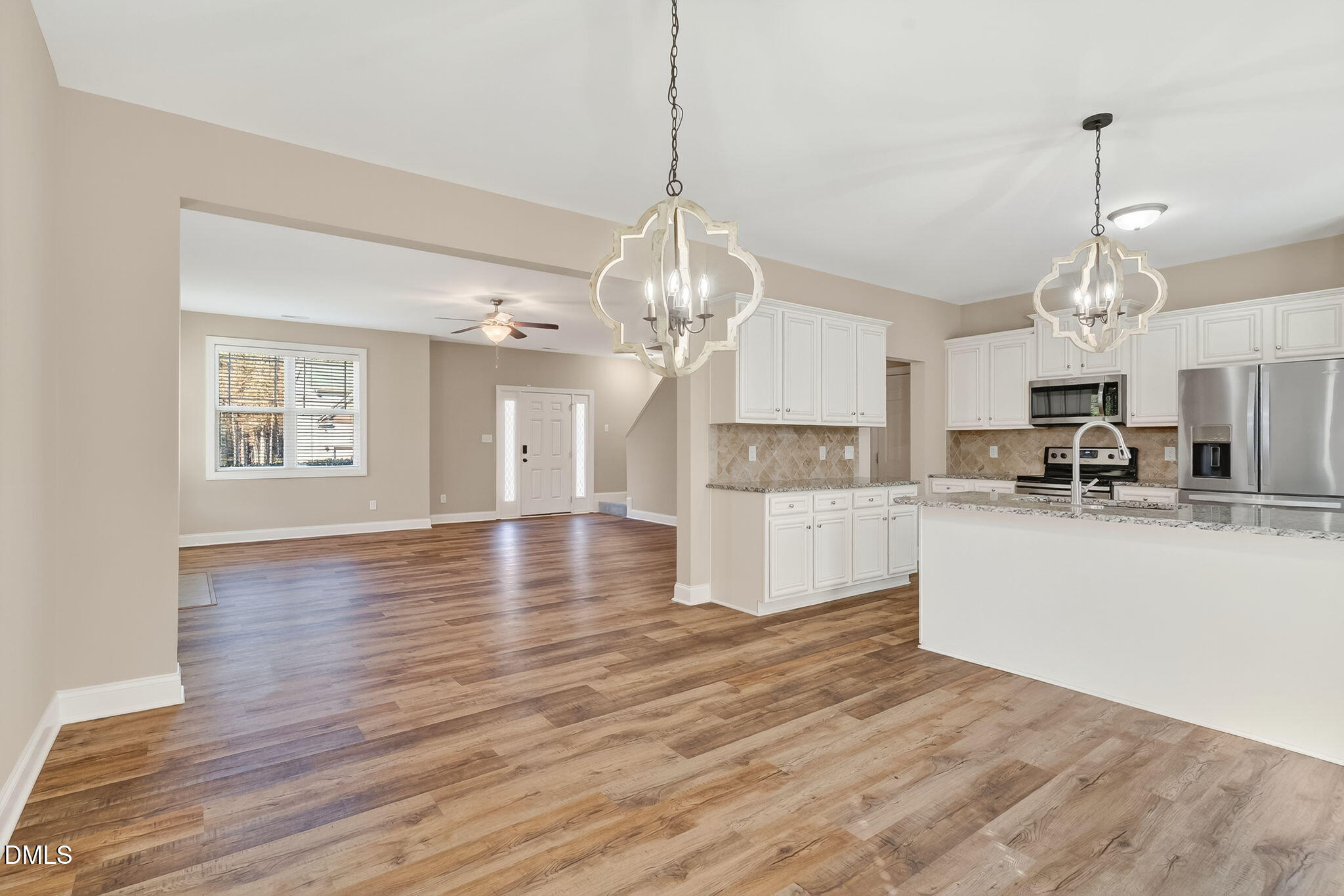 118 Landlocked Circle Angier, NC 27501 - Photo 8 of 27 a view of a kitchen with granite countertop wooden floor stainless steel appliances and a chandelier