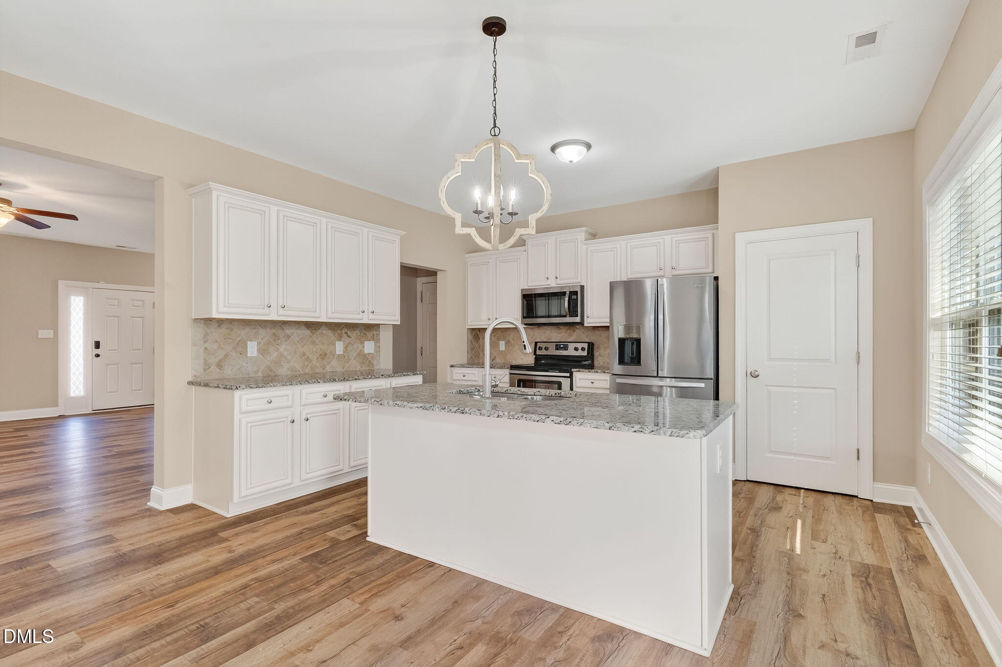 118 Landlocked Circle Angier, NC 27501 - Photo 9 of 27 a kitchen with stainless steel appliances granite countertop a refrigerator a stove a sink dishwasher and white cabinets with wooden floor