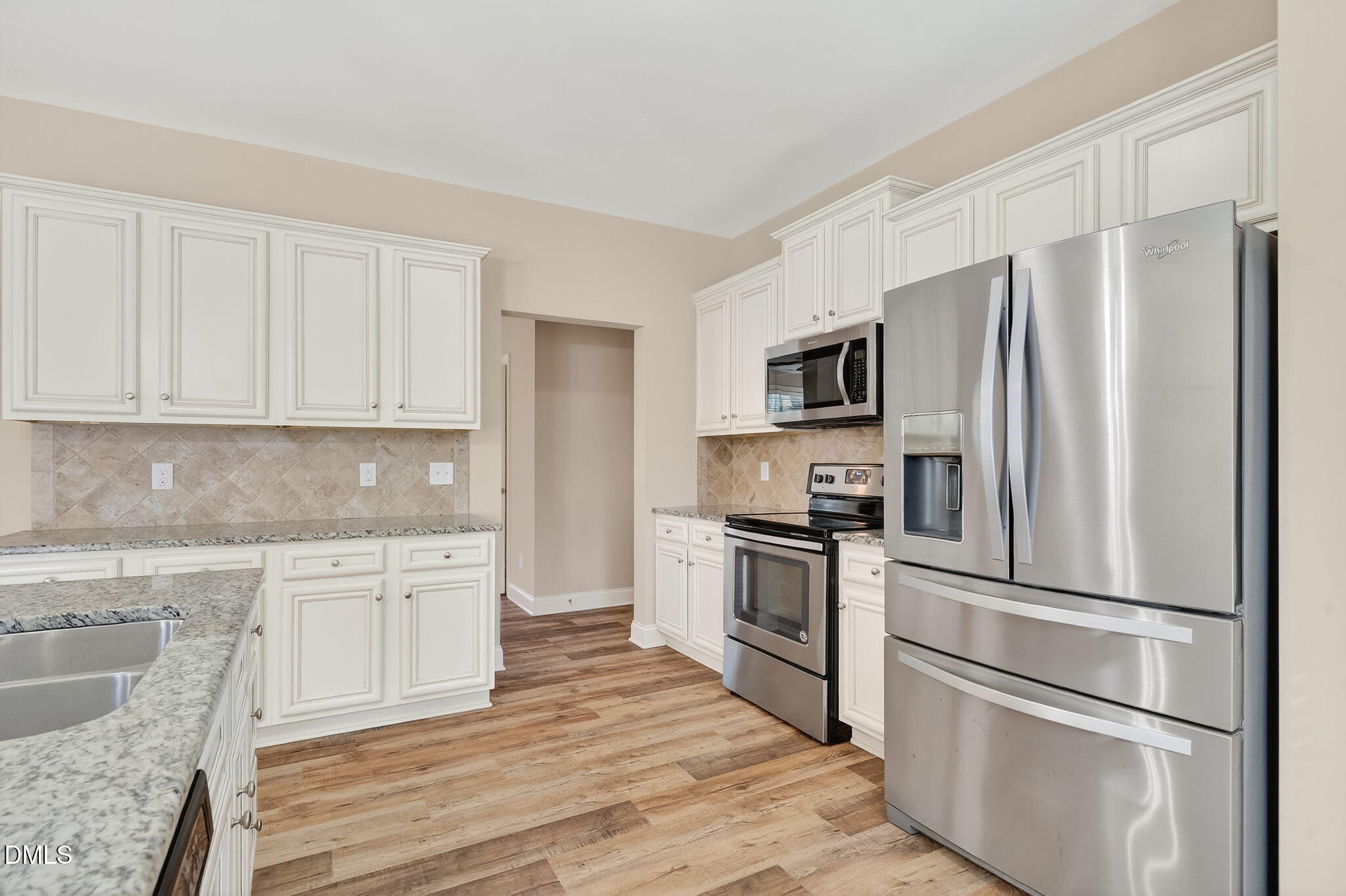 118 Landlocked Circle Angier, NC 27501 - Photo 10 of 27 a kitchen with granite countertop white cabinets and stainless steel appliances