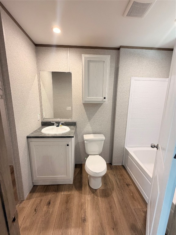 4782 Fm 1010 Road Cleveland, TX 77327 - Photo 14 of 16 a bathroom with a toilet a sink a mirror and vanity