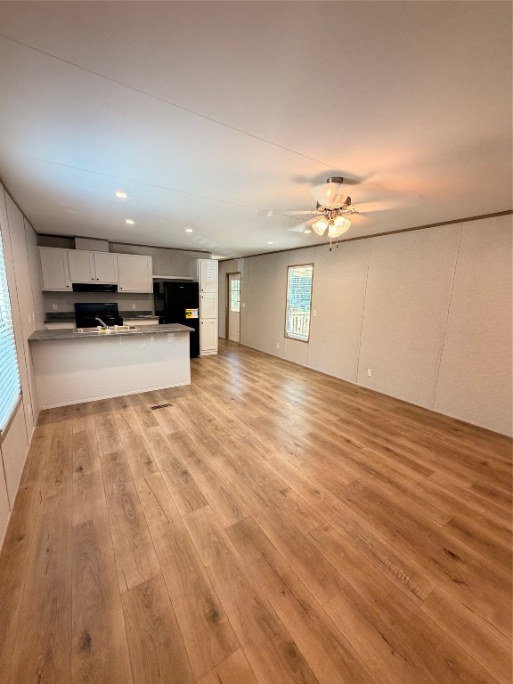 4782 Fm 1010 Road Cleveland, TX 77327 - Photo 4 of 16 an empty room with wooden floor and kitchen view