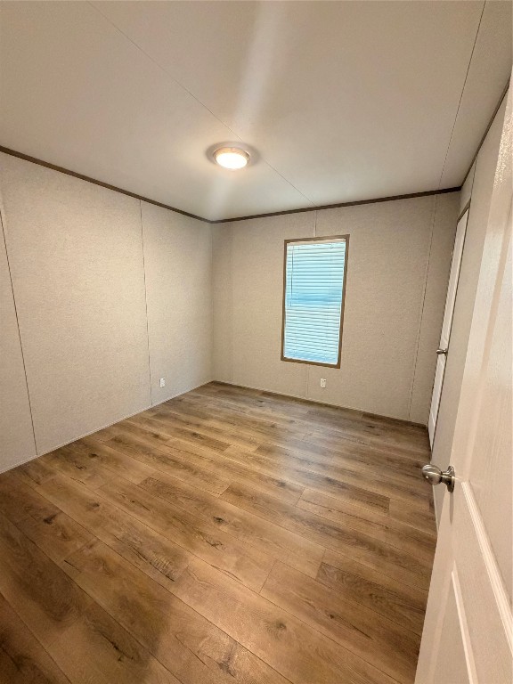 4782 Fm 1010 Road Cleveland, TX 77327 - Photo 7 of 16 an empty room with wooden floor and windows