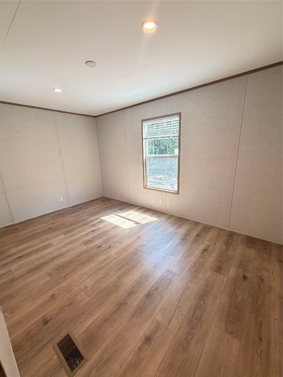 4782 Fm 1010 Road Cleveland, TX 77327 - Photo 9 of 16 an empty room with wooden floor and windows