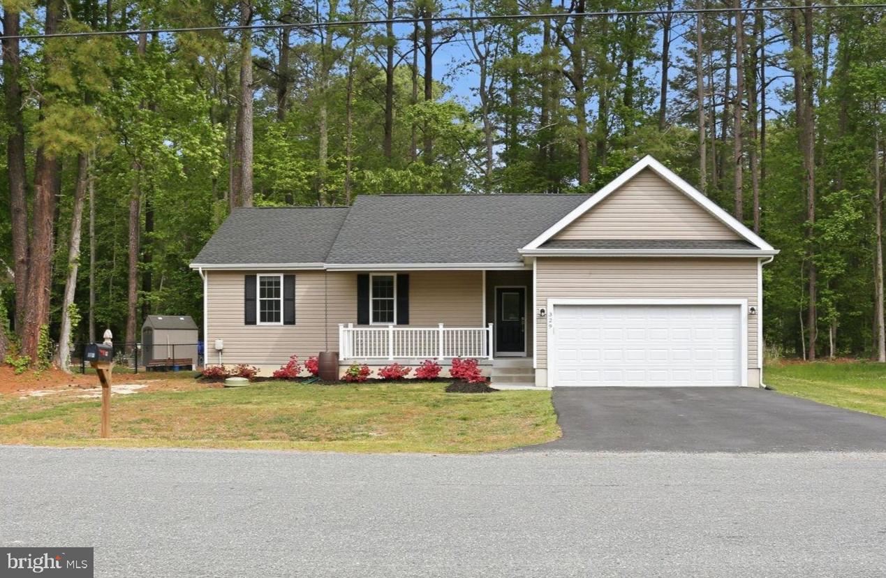 329 North Glebe Road Montross, VA 22520 - Photo 1 of 39 a front view of house with yard and trees in the background