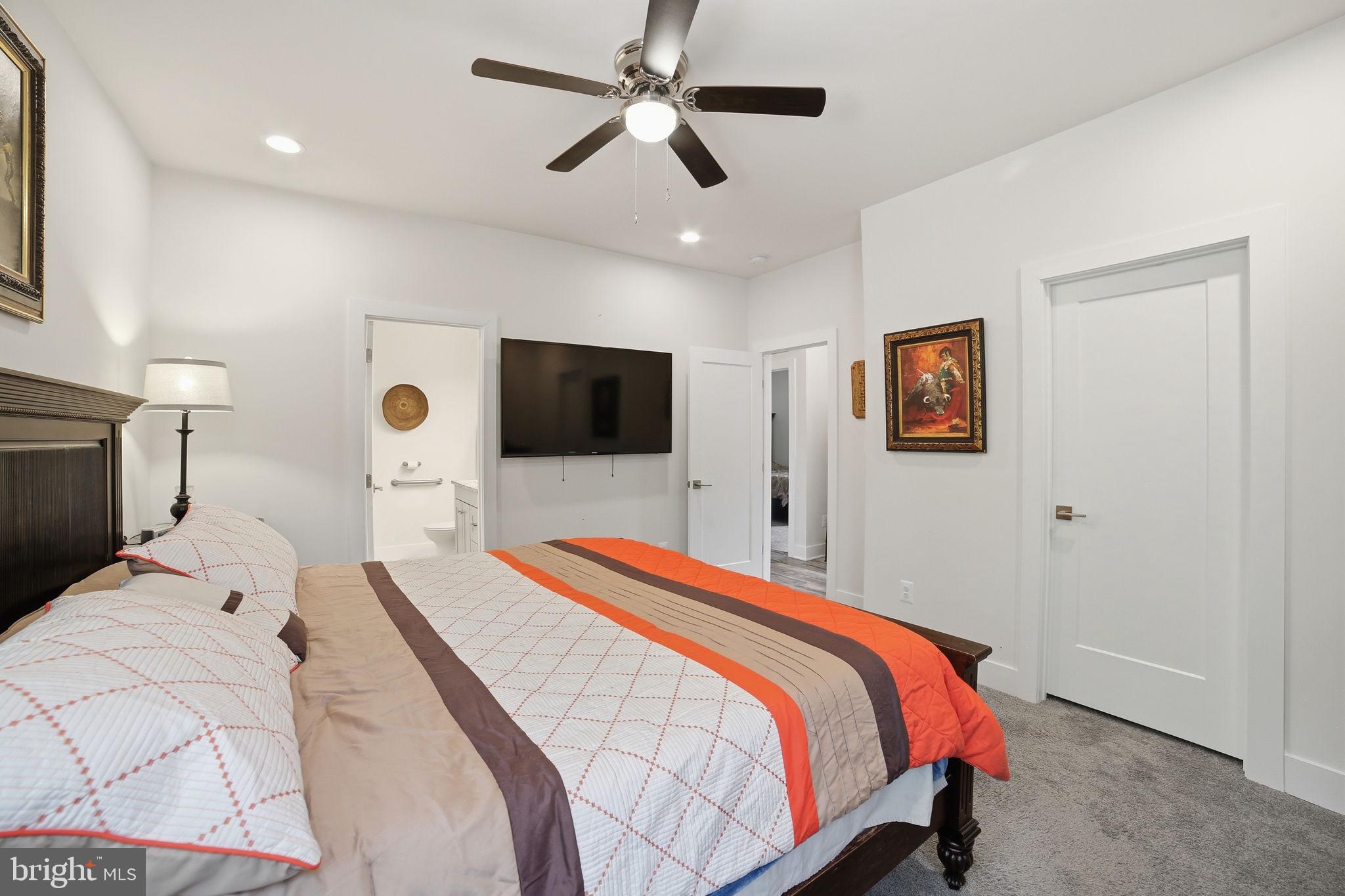 329 North Glebe Road Montross, VA 22520 - Photo 14 of 39 a bedroom with a bed and a flat screen tv