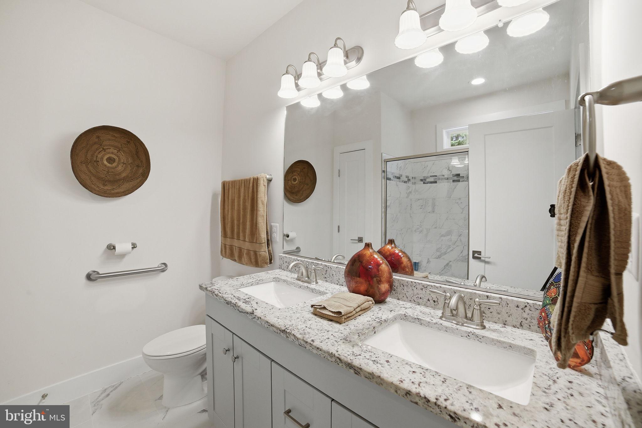 329 North Glebe Road Montross, VA 22520 - Photo 16 of 39 a bathroom with a granite countertop sink a toilet and a mirror