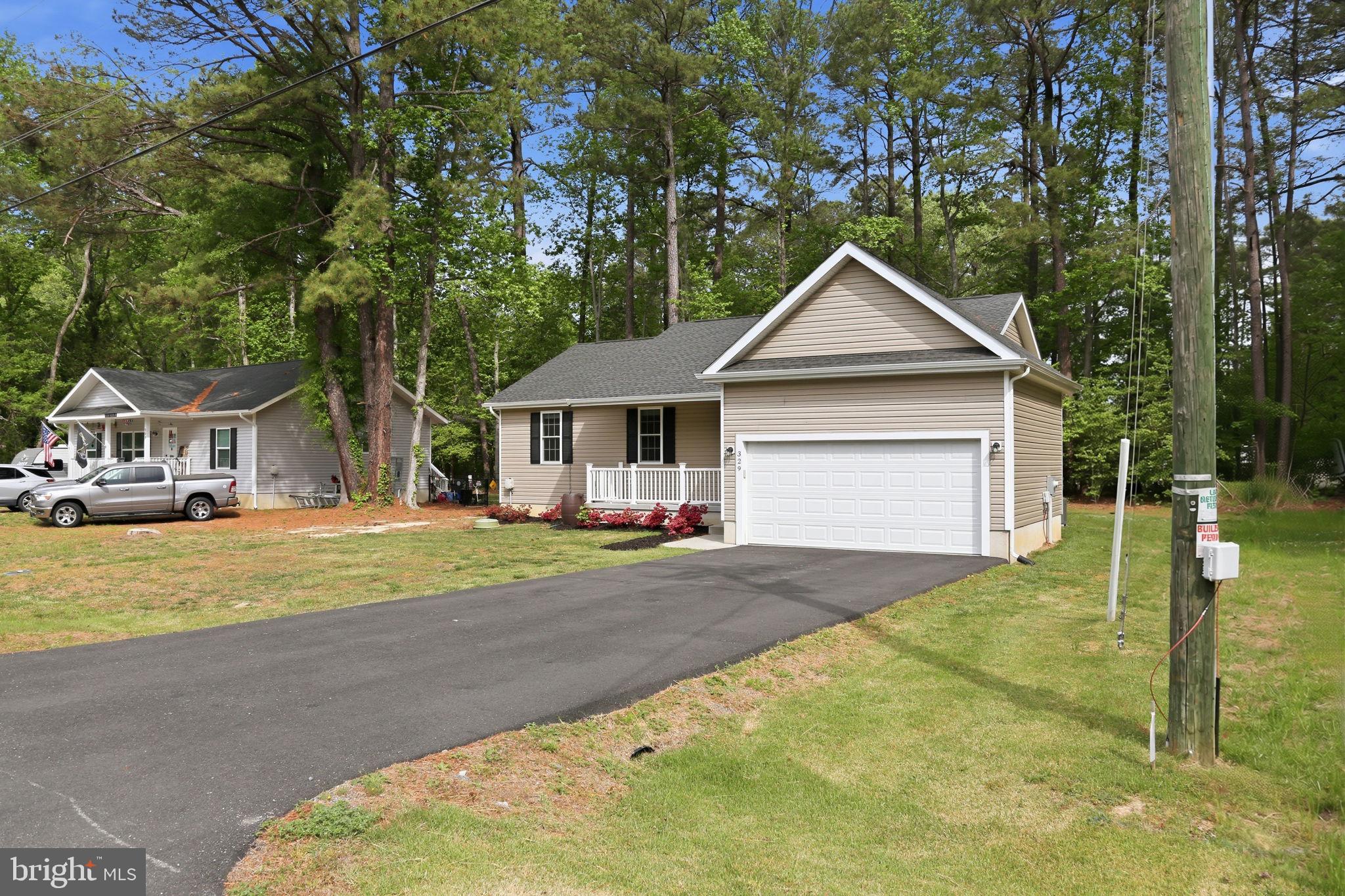 329 North Glebe Road Montross, VA 22520 - Photo 33 of 39 a front view of a house with a yard and garage