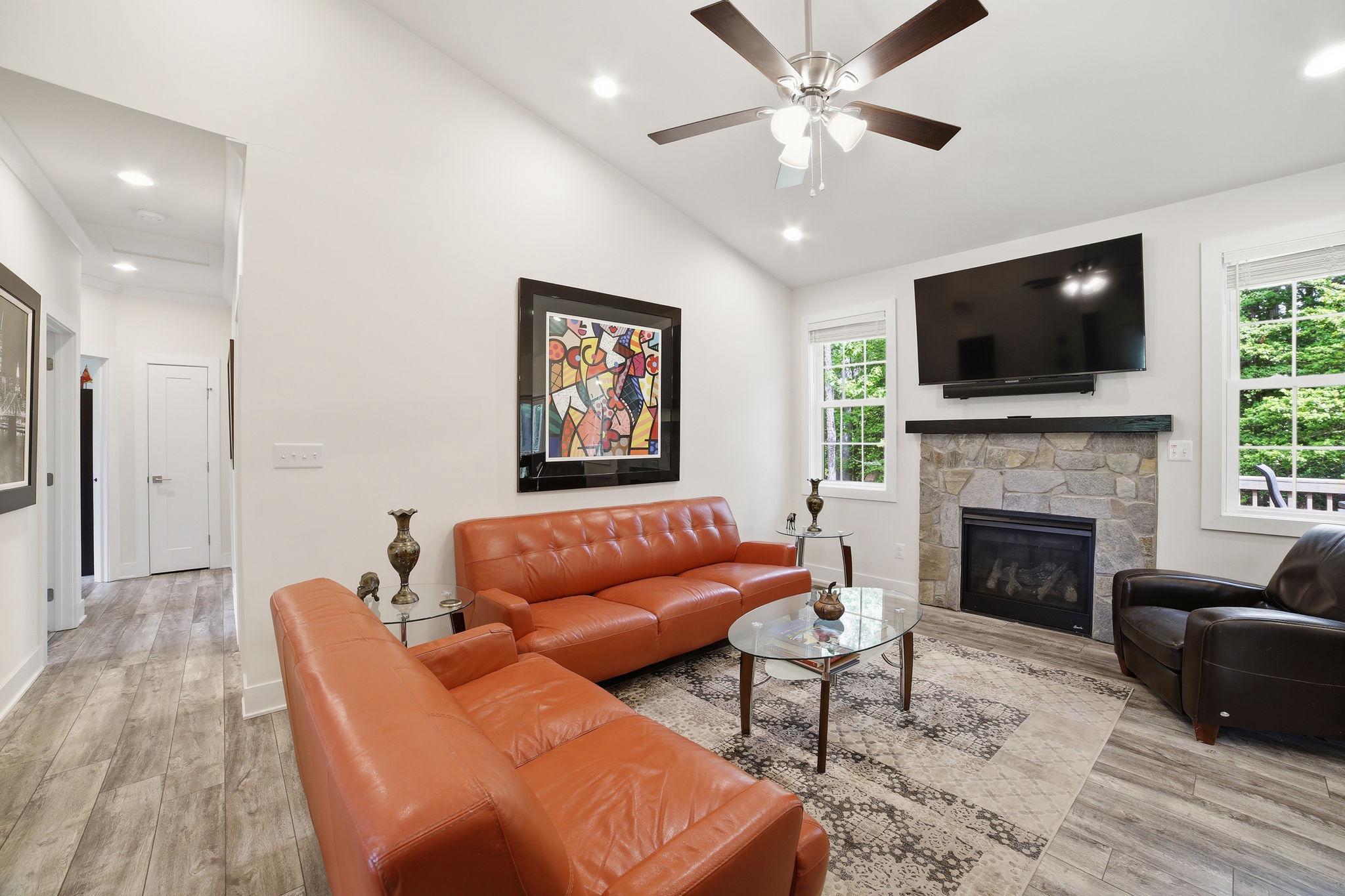 329 North Glebe Road Montross, VA 22520 - Photo 5 of 39 a living room with furniture a flat screen tv and a fireplace