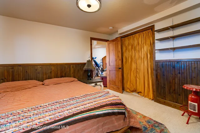 a bed sitting in a bedroom next to a window