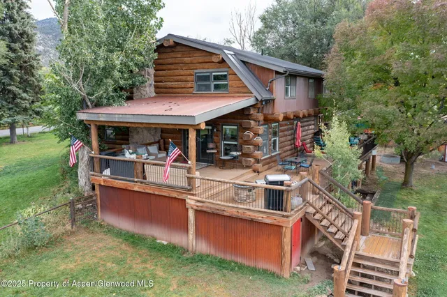 a view of a house with a chairs and table in a patio