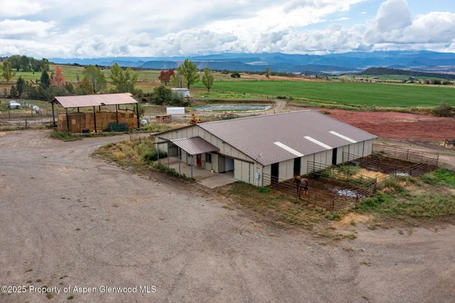 an aerial view of a houses with yard