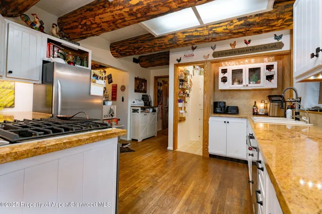 a kitchen with stainless steel appliances granite countertop a stove and a refrigerator