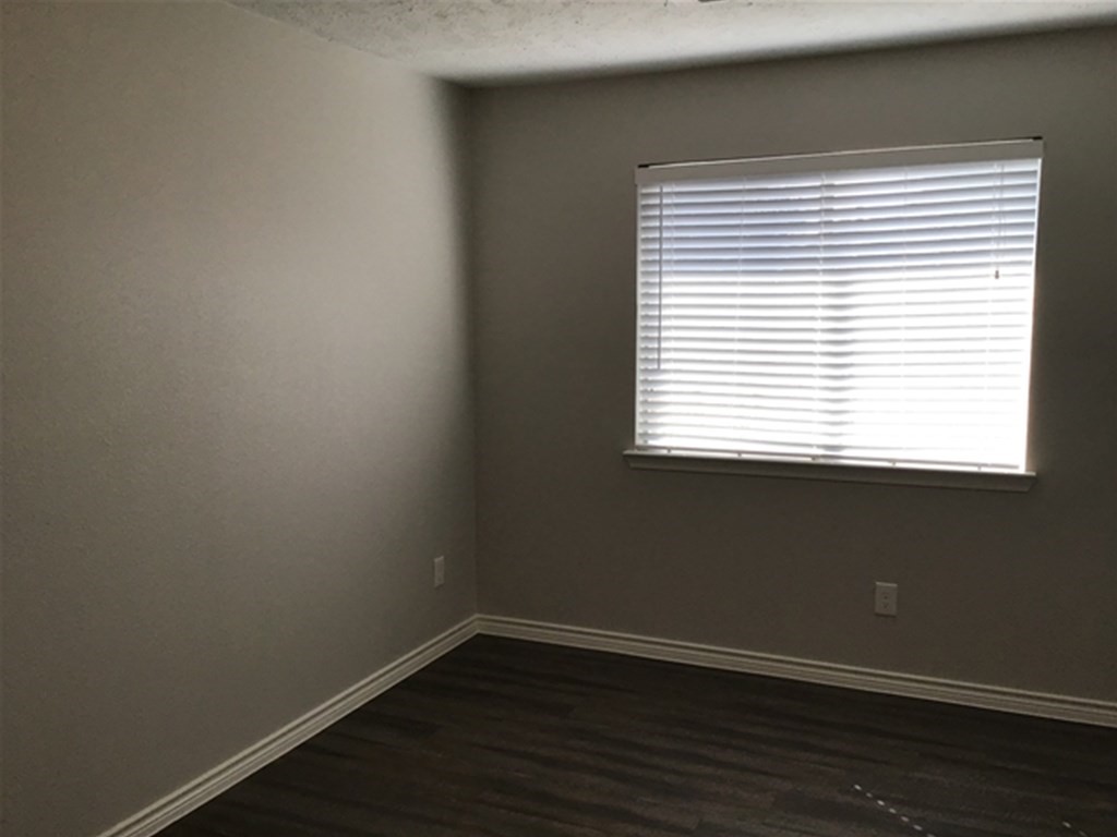 5026 Chase Stone Drive Bacliff, TX 77518 - Photo 14 of 18 an empty room with wooden floor and a window