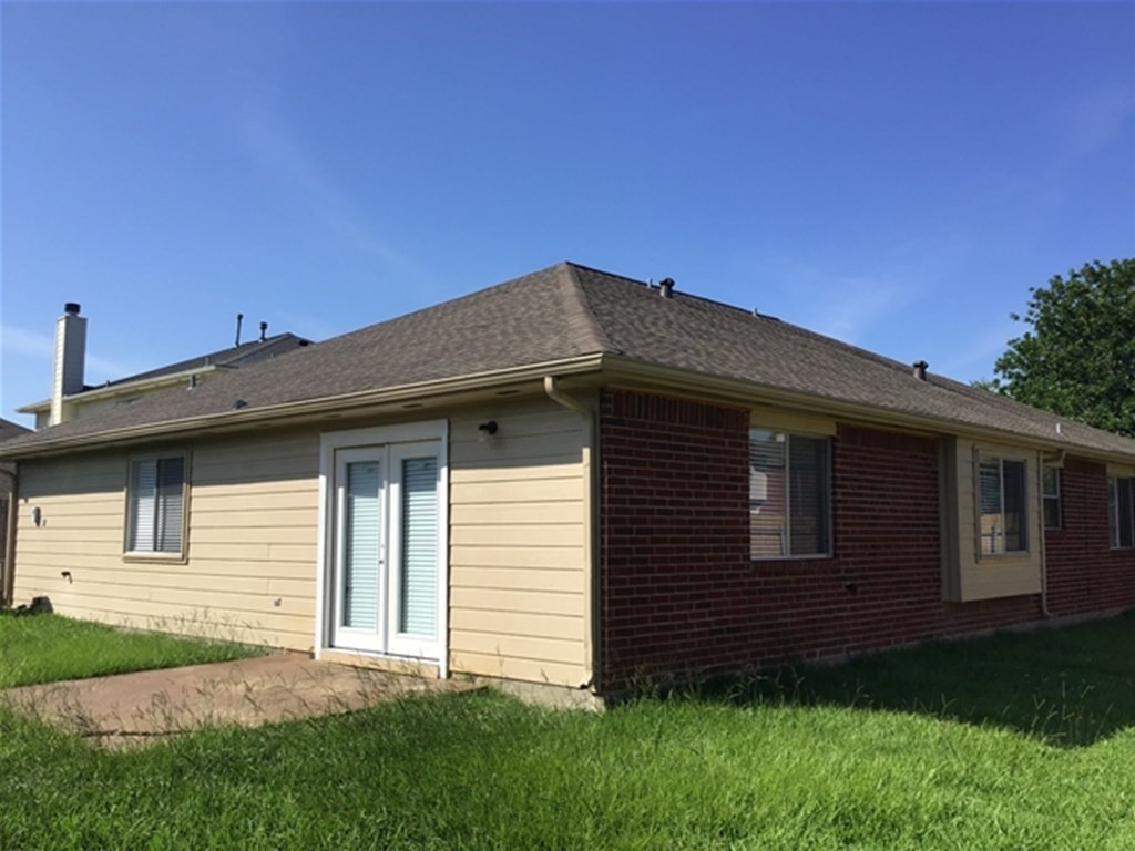 5026 Chase Stone Drive Bacliff, TX 77518 - Photo 18 of 18 a front view of a house with a garden