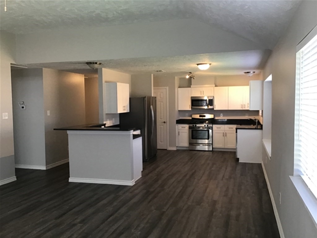 5026 Chase Stone Drive Bacliff, TX 77518 - Photo 2 of 18 a kitchen with stainless steel appliances a refrigerator and wooden floor